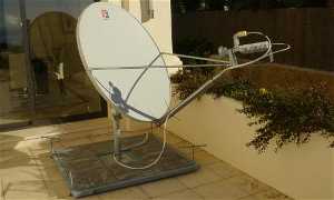 Fixed two-way satellite broadband on non-penetrating mount, held down by the weight of the blocks