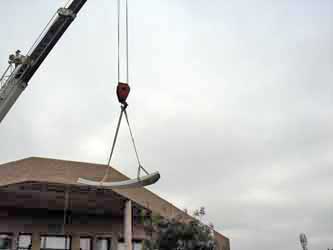 Using crane to lift the antenna reflector panels