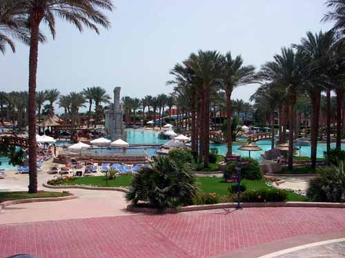 Hotel gardens and pools looking down from reception plaza towards the beach.