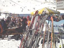 Skis stacked outside in the snow during lunch