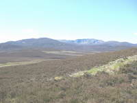 Views across scottish hills on clear sunny day walking.