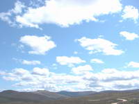 Blue sky and clouds; a windy but sunny day.